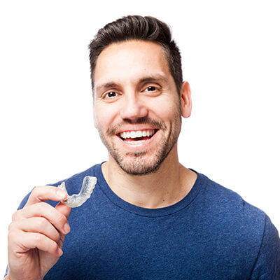 A man holding Invisalign clear aligners